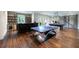 Spacious game room featuring a ping pong table, pool table, bar, and hardwood floors at 4975 Rebel Trl, Atlanta, GA 30327
