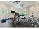 Well-equipped gym with treadmill, weights, mirrored wall, and natural light at 4975 Rebel Trl, Atlanta, GA 30327
