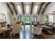 Bright living room with wood beam ceiling, large windows overlooking backyard and access to outdoor pool at 4975 Rebel Trl, Atlanta, GA 30327