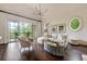 Bright living room with balcony, hardwood floors, comfortable seating, and modern light fixture at 4975 Rebel Trl, Atlanta, GA 30327