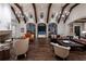 Stately living room with grand windows, beamed ceiling, and cozy fireplace at 4975 Rebel Trl, Atlanta, GA 30327
