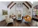 Bright, open living room featuring a fireplace, wood beams, hardwood floors, and an arched doorway at 4975 Rebel Trl, Atlanta, GA 30327