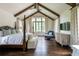 Spacious main bedroom featuring vaulted ceiling, exposed beams, hardwood floors, and large windows at 4975 Rebel Trl, Atlanta, GA 30327