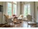Cozy sitting area featuring three chairs, wooden floors, and two windows at 4975 Rebel Trl, Atlanta, GA 30327