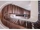 Aerial view of a curved wooden staircase with wrought iron railing and natural light at 4975 Rebel Trl, Atlanta, GA 30327