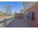 Back deck with a dark wood floor and a brick wall at 775 Mountain View Nw Ter, Marietta, GA 30064