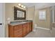 Bathroom featuring a granite countertop, wooden vanity, and decorative mirror at 775 Mountain View Nw Ter, Marietta, GA 30064