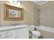 Bright bathroom features tiled shower, white vanity, and decorative mirror at 775 Mountain View Nw Ter, Marietta, GA 30064