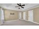 Spacious bedroom featuring tray ceilings, neutral colors, and a ceiling fan at 775 Mountain View Nw Ter, Marietta, GA 30064
