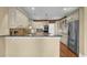 Modern kitchen features stainless steel appliances, light countertops, white cabinets, and wood flooring at 775 Mountain View Nw Ter, Marietta, GA 30064