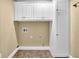 White laundry room with overhead cabinets at 775 Mountain View Nw Ter, Marietta, GA 30064