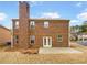 Brick home exterior with a patio and chimney in the backyard at 12981 Dartmore Cir, Alpharetta, GA 30005