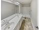 Bathroom featuring double sinks, a large mirror, and a shower-tub combination at 12981 Dartmore Cir, Alpharetta, GA 30005