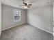 Bedroom with neutral walls, a window, ceiling fan and carpeted floors at 12981 Dartmore Cir, Alpharetta, GA 30005