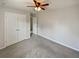 This inviting bedroom is bathed in natural light, enhancing its ceiling fan and ample closet space at 12981 Dartmore Cir, Alpharetta, GA 30005