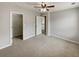 Spacious bedroom with neutral walls, plush carpet, a ceiling fan, and a walk-in closet at 12981 Dartmore Cir, Alpharetta, GA 30005