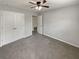 This well-lit bedroom is complemented by a ceiling fan and is complete with double door closet storage at 12981 Dartmore Cir, Alpharetta, GA 30005