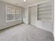 Bedroom with carpeted floors and built in white shelving units at 12981 Dartmore Cir, Alpharetta, GA 30005