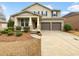 Charming two-story home features a well-manicured lawn, two-car garage and covered porch with stone accents at 12981 Dartmore Cir, Alpharetta, GA 30005
