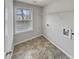 A practical laundry room is enhanced by a window with exterior views, along with convenient hookups at 12981 Dartmore Cir, Alpharetta, GA 30005