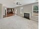 An open-concept living room boasts a fireplace and seamless flow to the kitchen with stainless appliances at 12981 Dartmore Cir, Alpharetta, GA 30005