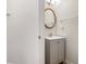 This charming half bath features a vanity with a sink and a gold framed mirror at 2225 Saint Thomas Way, Suwanee, GA 30024