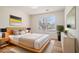 Staged bedroom with wood floors, a bed, and a window offering natural light at 2225 Saint Thomas Way, Suwanee, GA 30024