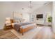 Staged bedroom with vaulted ceilings, wood floors, a bed, and a window offering natural light at 2225 Saint Thomas Way, Suwanee, GA 30024