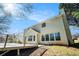 Back of house showing large deck and multiple windows under a sunny sky at 2225 Saint Thomas Way, Suwanee, GA 30024
