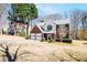 Charming two-story home with a brick front and attached two-car garage surrounded by mature trees at 2225 Saint Thomas Way, Suwanee, GA 30024