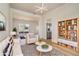 Stylish living room with modern decor, a cozy seating area, and views into the adjacent kitchen at 2225 Saint Thomas Way, Suwanee, GA 30024