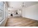 Open-concept living space with wood flooring, leading to the kitchen and dining area; bright and inviting at 2225 Saint Thomas Way, Suwanee, GA 30024