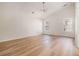 Room featuring vaulted ceilings, wood floors, and large windows offering ample natural light at 2225 Saint Thomas Way, Suwanee, GA 30024