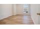 Cozy room featuring wood floors, base trim and a window offering natural light at 2225 Saint Thomas Way, Suwanee, GA 30024