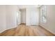 Room featuring wood floors, base trim, a window, and multiple doors at 2225 Saint Thomas Way, Suwanee, GA 30024