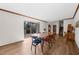 Stylish dining area with wood floors, a spacious table, and a sliding glass door overlooking the backyard at 230 N Talbot Ct, Roswell, GA 30076