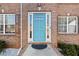 Stylish blue front door with glass panels and white trim, flanked by windows and green bushes at 4046 Arnolds Mill Opas, Douglasville, GA 30135