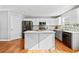 Modern kitchen with white cabinets, a center island, stainless steel appliances, and hardwood floors at 4046 Arnolds Mill Opas, Douglasville, GA 30135