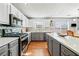 Modern kitchen features gray and white cabinets, stainless steel appliances, and a kitchen island at 4046 Arnolds Mill Opas, Douglasville, GA 30135