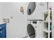 Modern laundry area with stacked washer and dryer and storage shelves at 4046 Arnolds Mill Opas, Douglasville, GA 30135