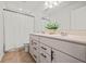 Bright bathroom features a double sink vanity, and a shower with neutral tile at 828 Royal Red Ct, Mcdonough, GA 30253
