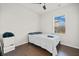 Simple bedroom with a full-sized bed, neutral walls, and a window with blinds at 828 Royal Red Ct, Mcdonough, GA 30253