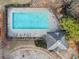 Bird's eye view of a pool with surrounding greenery and an adjacent building at 828 Royal Red Ct, Mcdonough, GA 30253
