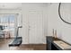 Clean entryway featuring a white door, adjacent to hardwood floors, with a console table at 828 Royal Red Ct, Mcdonough, GA 30253