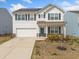 Charming two-story home featuring a welcoming front porch, two car garage and solar panels at 828 Royal Red Ct, Mcdonough, GA 30253