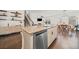 Kitchen island with stainless steel dishwasher and open to dining and living rooms at 828 Royal Red Ct, Mcdonough, GA 30253