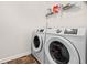 Functional laundry room with a modern washing machine and dryer set, plus shelving at 828 Royal Red Ct, Mcdonough, GA 30253
