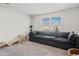 Comfortable living room featuring a large gray sofa, carpeted floor and natural light at 828 Royal Red Ct, Mcdonough, GA 30253