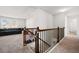 Spacious loft with staircase featuring black railings, and large windows at 828 Royal Red Ct, Mcdonough, GA 30253