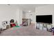 Bright playroom with carpeted floors, toys, and plenty of open space for activities at 828 Royal Red Ct, Mcdonough, GA 30253